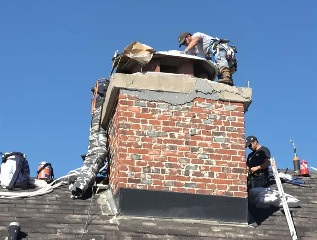 Scituate Chimney Sweep installing a custom chimney crown in Scituate, RI