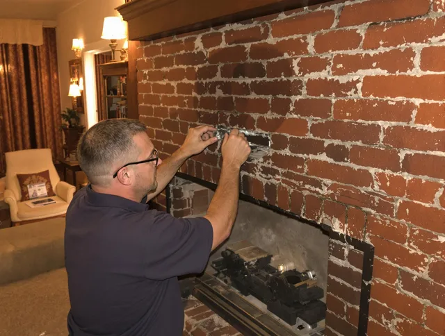 Scituate Chimney Sweep expert fixing a fireplace in Scituate, RI